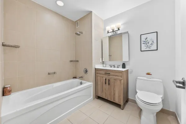 a bathroom with a granite countertop toilet a sink and bathtub
