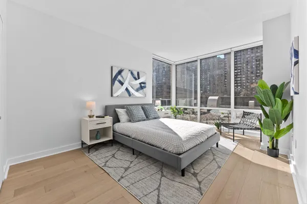 a bedroom with a bed and a large window