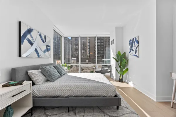 a bedroom with bed and a window