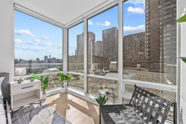 a living room filled with furniture and a potted plant