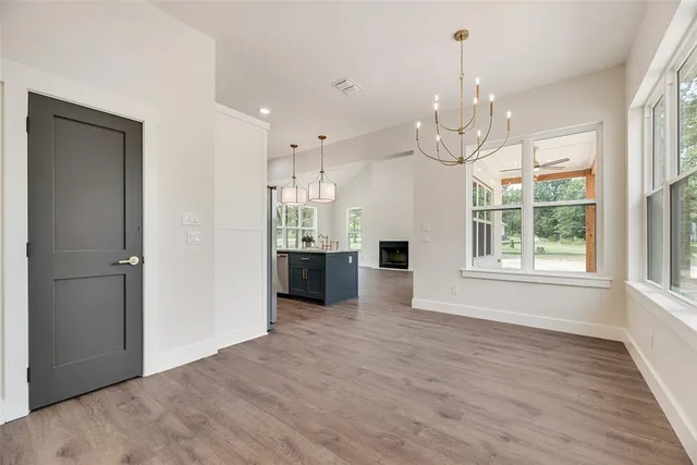a view of a kitchen with a sink dishwasher and wooden floor