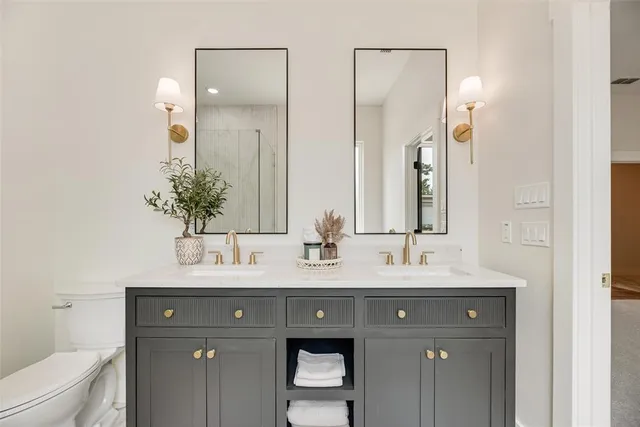 a bathroom with a double vanity sink and a mirror