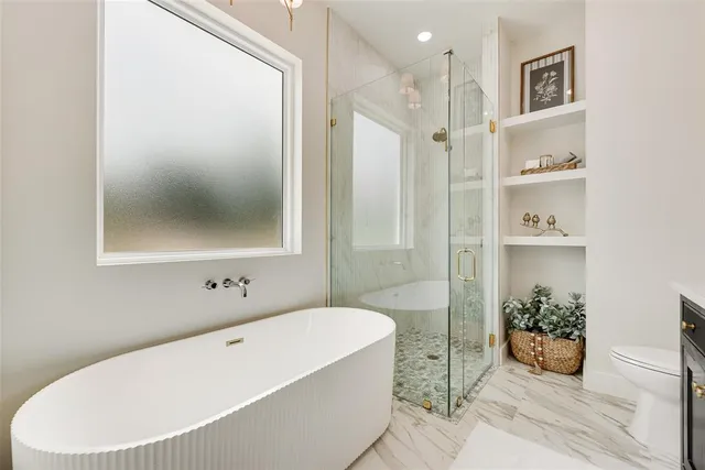 a bathroom with a tub shower and sink