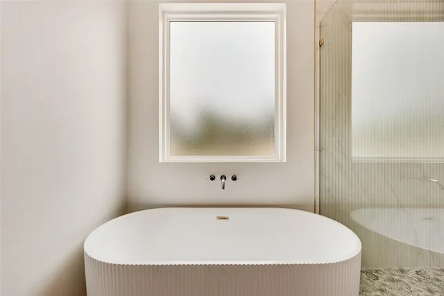 a white bath tub sitting next to a white sink