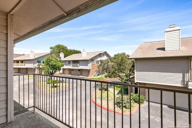 a view of a balcony with wooden floor