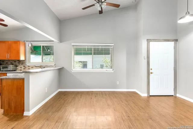 a view of a kitchen with wooden floor and a window