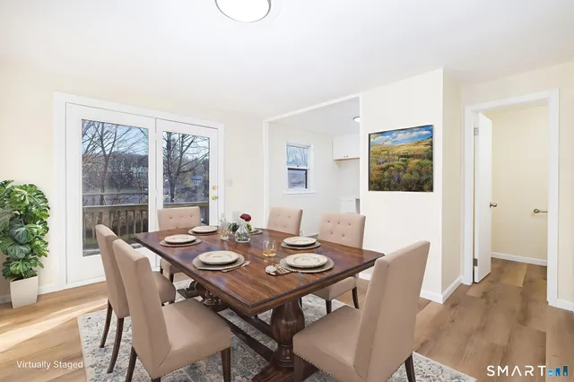 a view of a dining room with furniture window and wooden floor