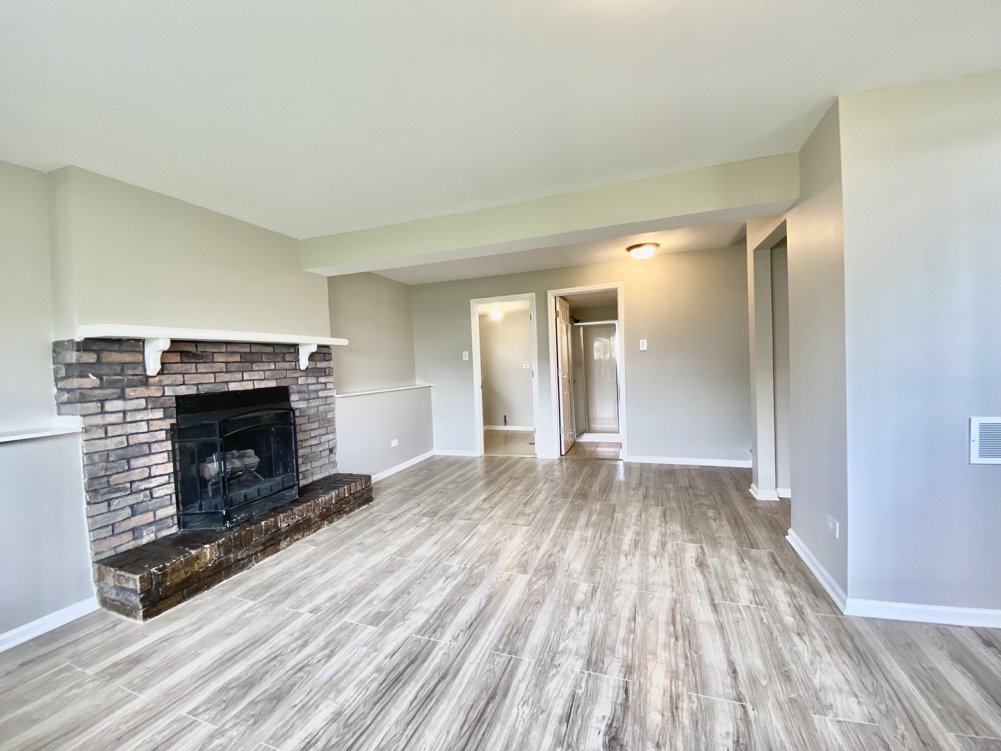 128 Timberlane Road Matteson, IL 60443 - Photo 22 of 28 a view of a livingroom with wooden floor and a fireplace