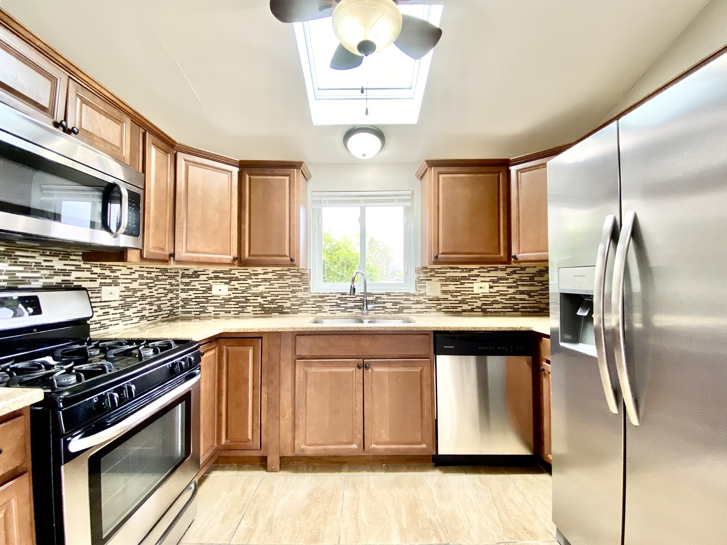 128 Timberlane Road Matteson, IL 60443 - Photo 7 of 28 a kitchen with stainless steel appliances granite countertop a sink stove and refrigerator