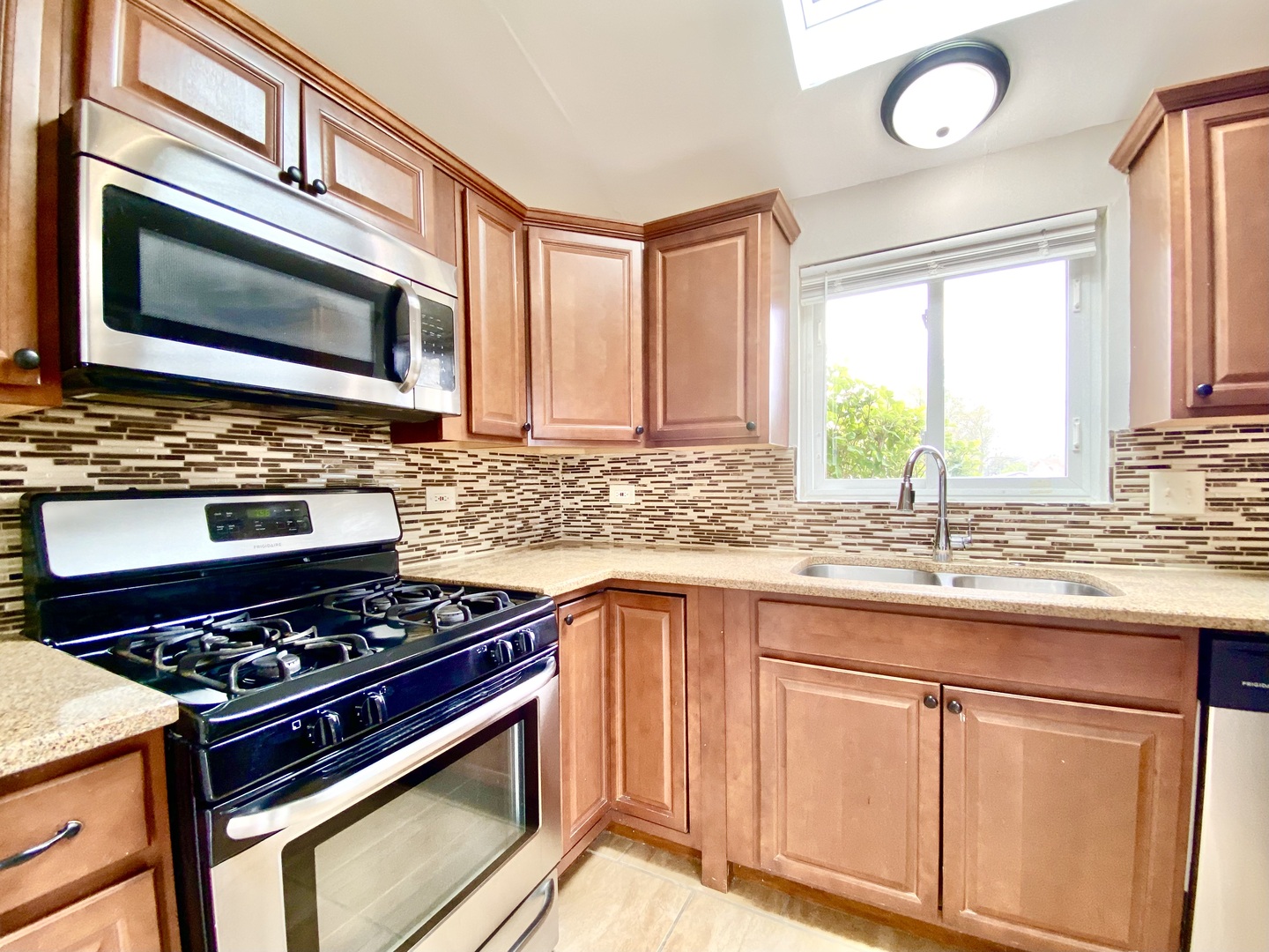 128 Timberlane Road Matteson, IL 60443 - Photo 8 of 28 a kitchen with granite countertop a stove and a sink