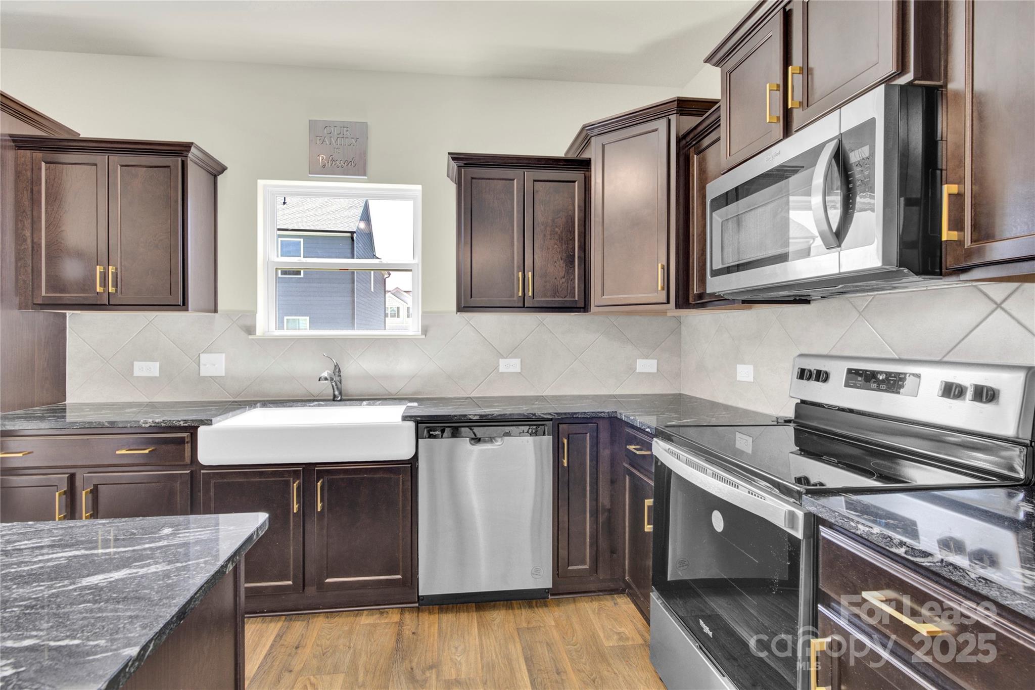 207 Aspire Circle, Unit 46 Wingate, NC 28174 - Photo 11 of 34 a kitchen with stainless steel appliances granite countertop a sink stove and cabinets