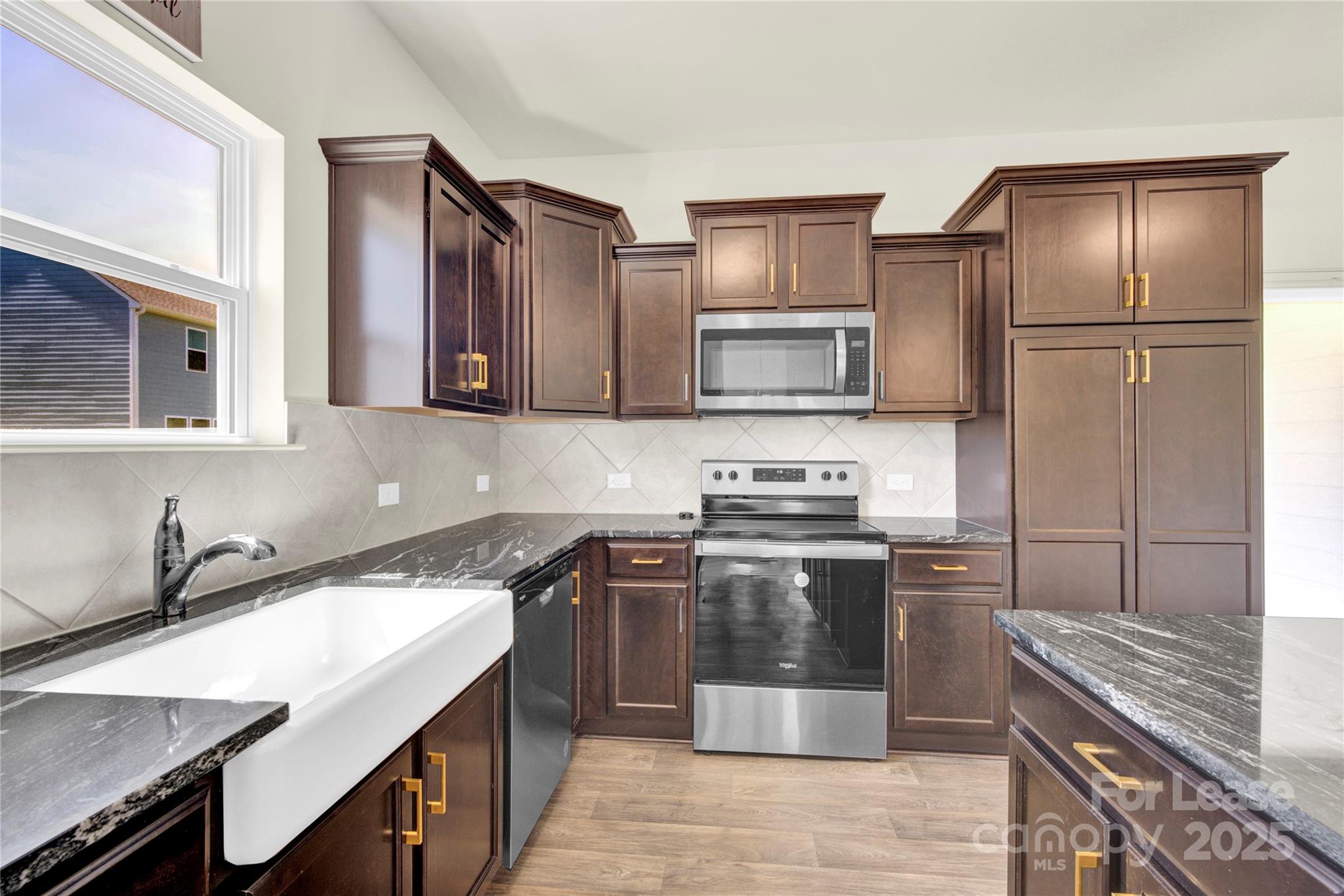 207 Aspire Circle, Unit 46 Wingate, NC 28174 - Photo 12 of 34 a kitchen with stainless steel appliances granite countertop a sink stove and refrigerator