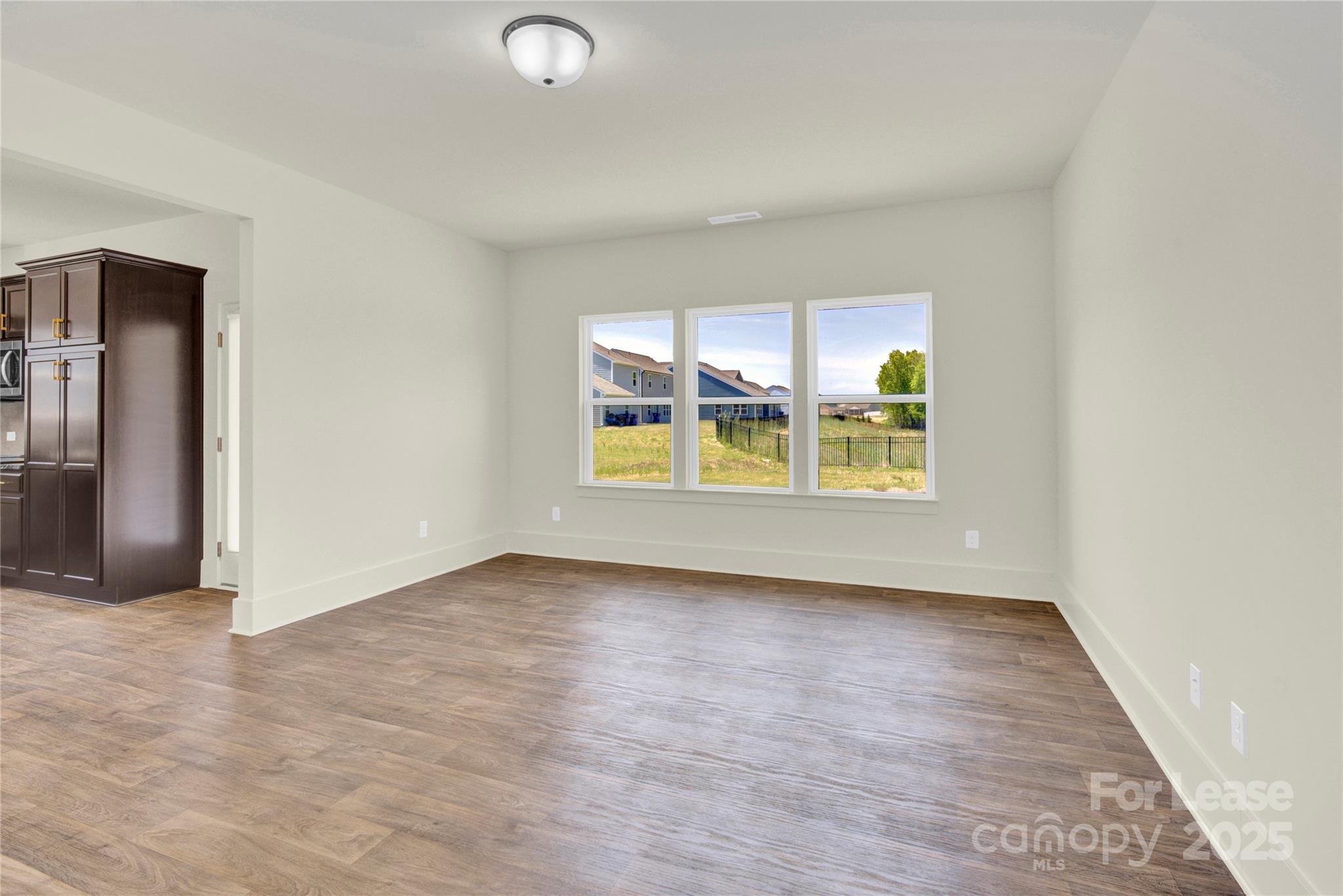 207 Aspire Circle, Unit 46 Wingate, NC 28174 - Photo 13 of 34 an empty room with windows