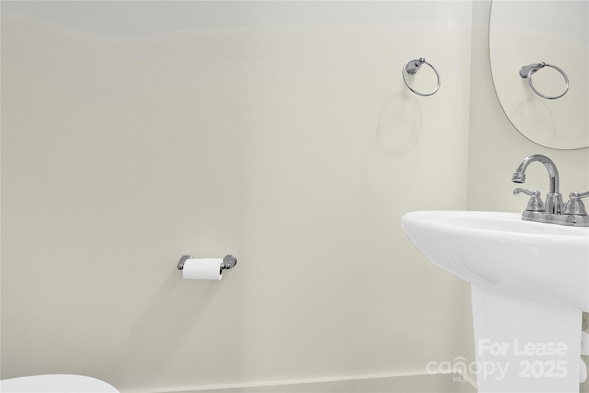 207 Aspire Circle, Unit 46 Wingate, NC 28174 - Photo 16 of 34 a bathroom with a sink and mirror