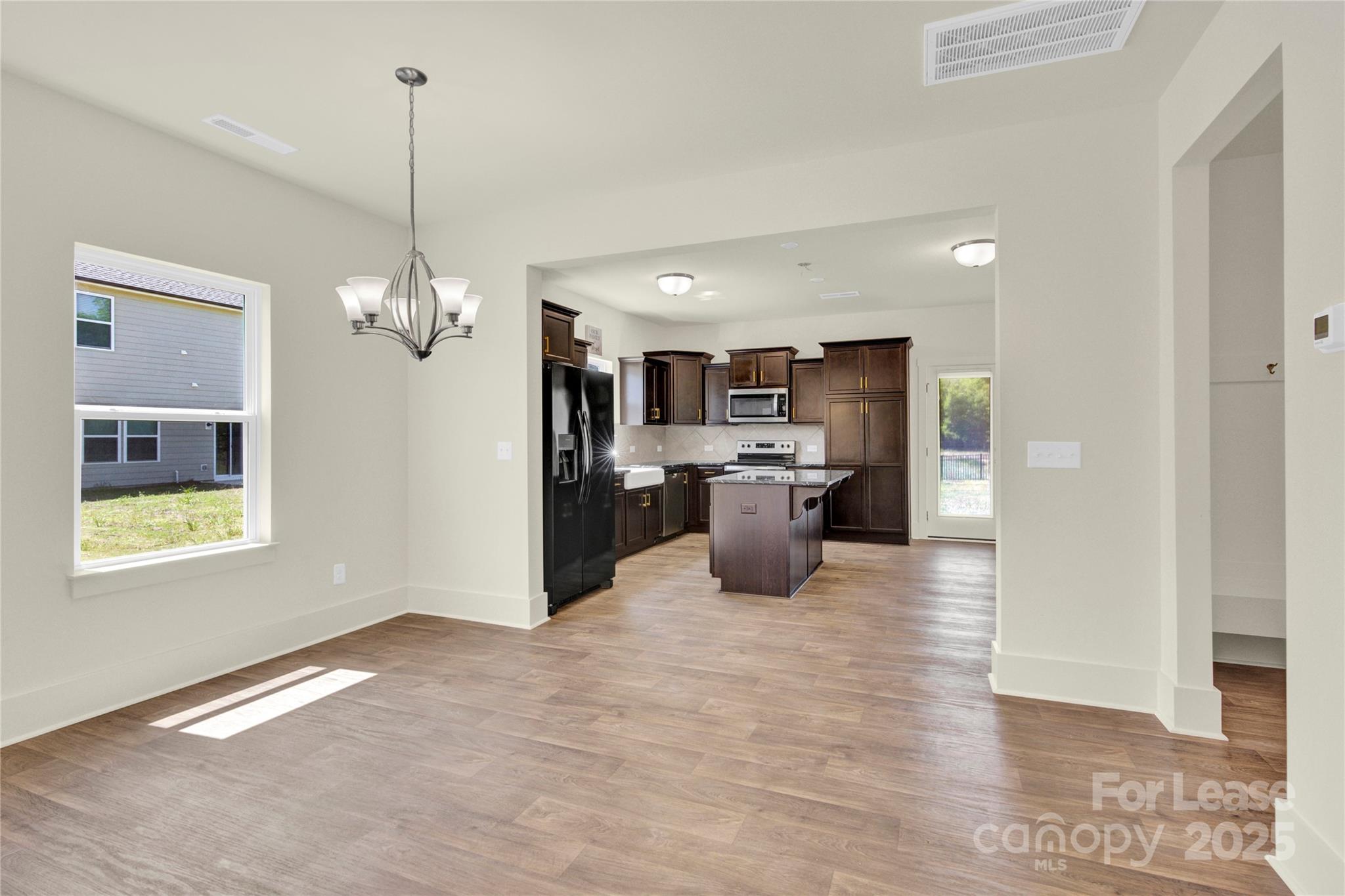207 Aspire Circle, Unit 46 Wingate, NC 28174 - Photo 3 of 34 a view of a big room with windows and chandelier