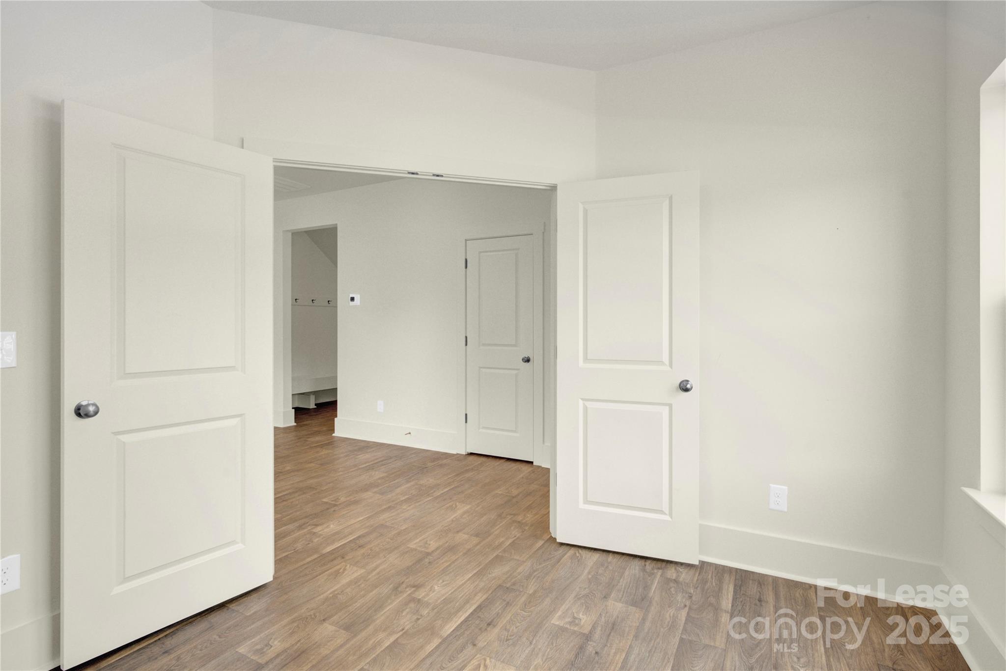 207 Aspire Circle, Unit 46 Wingate, NC 28174 - Photo 7 of 34 an empty room with wooden floor