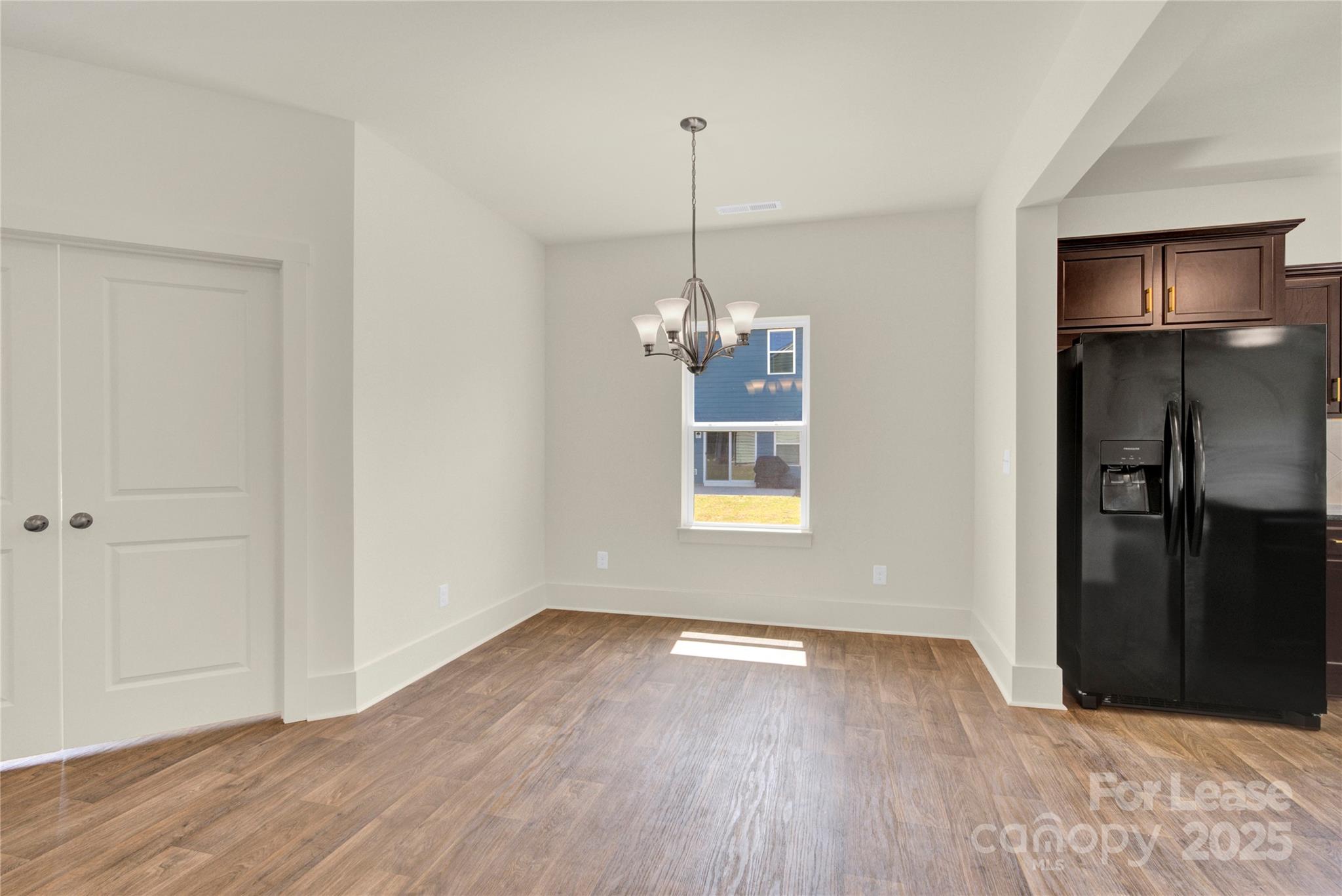 207 Aspire Circle, Unit 46 Wingate, NC 28174 - Photo 8 of 34 a view of a room with wooden floor and entryway
