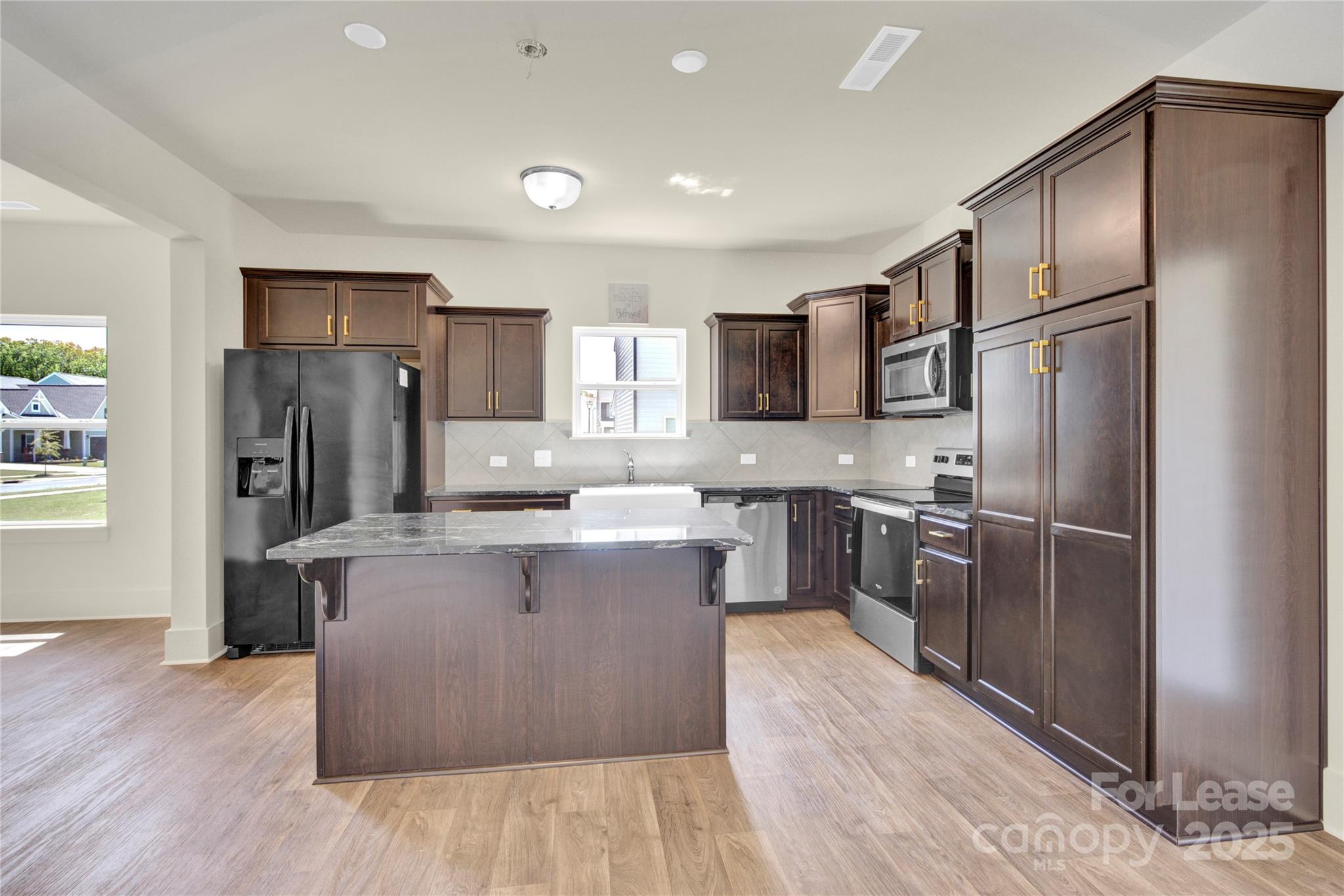 207 Aspire Circle, Unit 46 Wingate, NC 28174 - Photo 9 of 34 a kitchen with stainless steel appliances granite countertop a refrigerator and a stove top oven