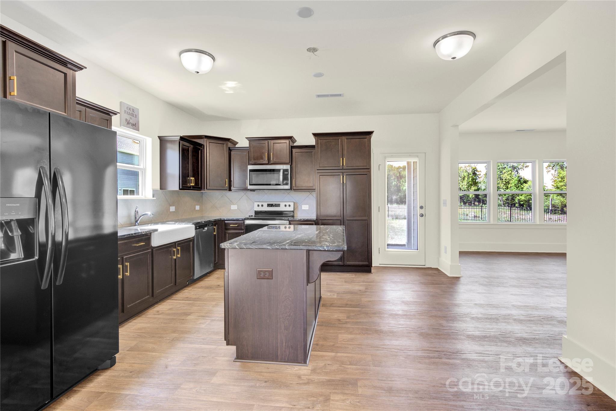 207 Aspire Circle, Unit 46 Wingate, NC 28174 - Photo 10 of 34 a kitchen with kitchen island granite countertop a refrigerator stove top oven and sink