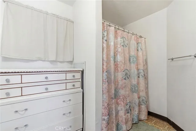a view of a closet with wooden floor