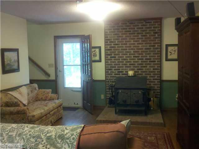 205 Mersey Road Greensboro, NC 27406 - Photo 4 of 12 Living Room. Living room with real hardwood floors and wood stove for chilly nights