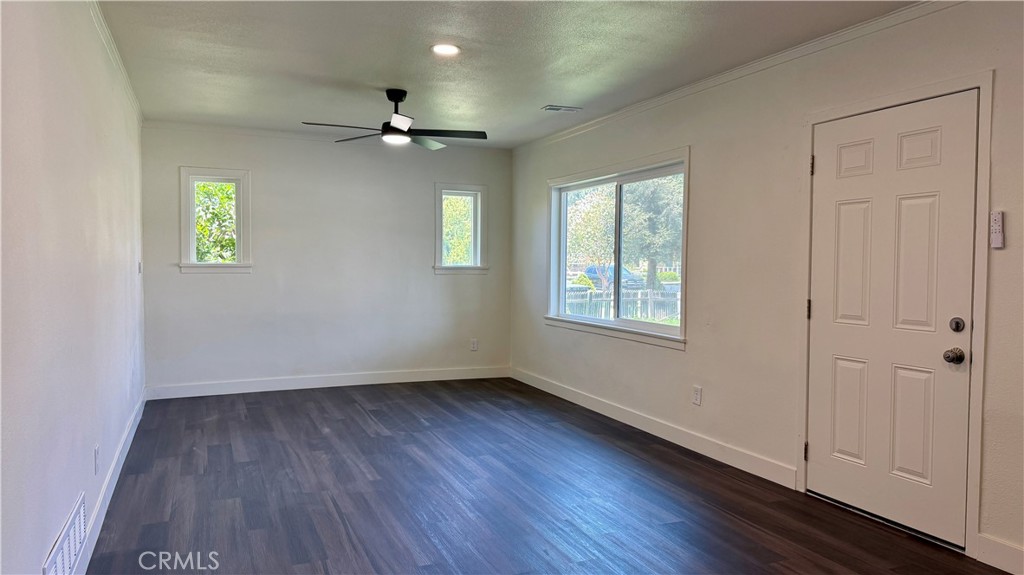 4542 Bandini Avenue Riverside, CA 92506 - Photo 7 of 22 a view of an empty room with a window and wooden floor
