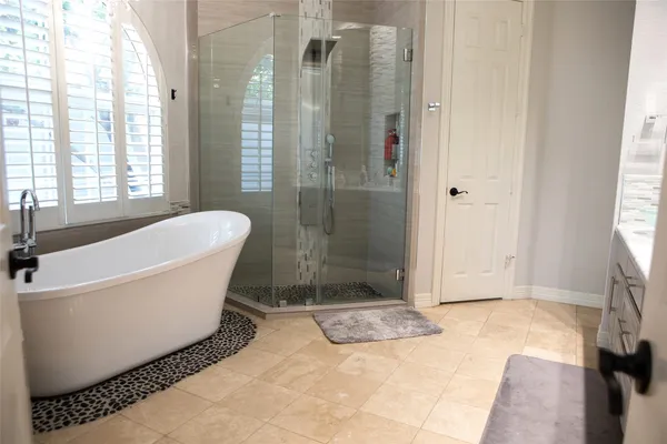 a bathroom with a bathtub and shower