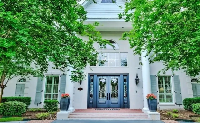 front view of a house with potted plants