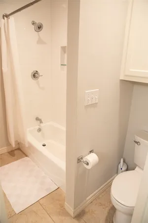 a bathroom with a bathtub and a toilet