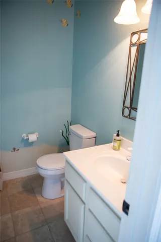a white toilet sitting next to a bathroom sink