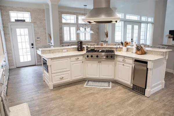a kitchen with a sink stove and cabinets