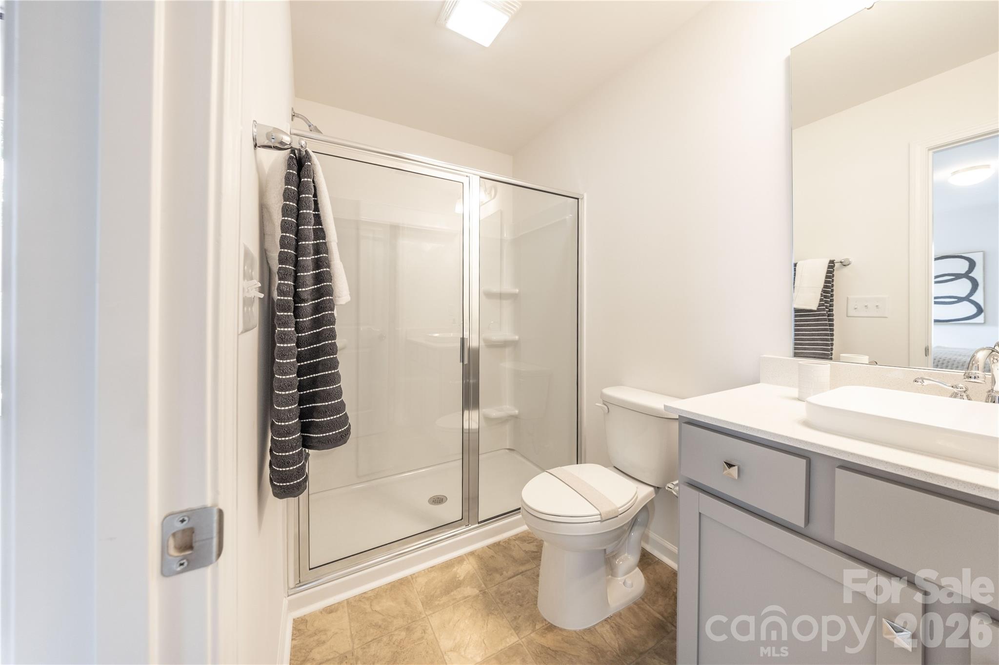 2928 Smithcliff Road, Unit 9 Charlotte, NC 28208 - Photo 12 of 12 a bathroom with a granite countertop sink toilet and shower