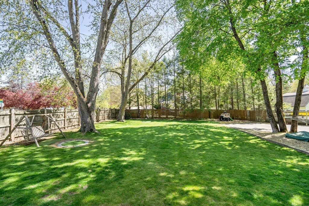 83 Ames Street Dedham, MA 02026 - Photo 33 of 33 a view of a backyard with large trees