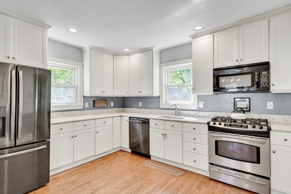 83 Ames Street Dedham, MA 02026 - Photo 10 of 33 a kitchen with cabinets stainless steel appliances and window