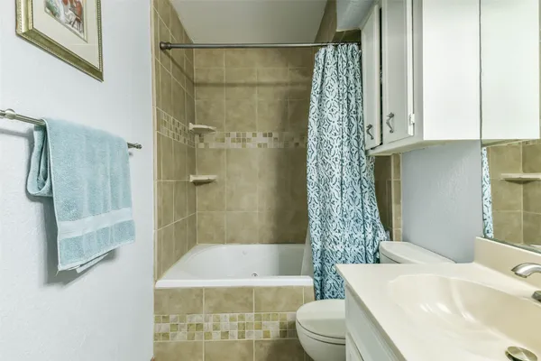 a bathroom with a sink a toilet a glass door shower and a bathtub