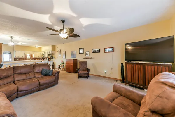 a living room with furniture ceiling fan and a rug