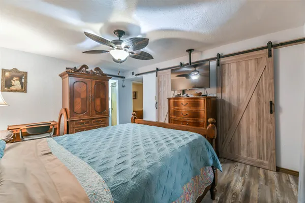 a bedroom with a bed and a chandelier