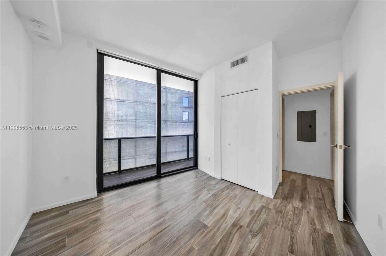 801 South Miami Avenue, Unit 5204 Miami, FL 33131 - Photo 18 of 31 wooden floor in an empty room with a window