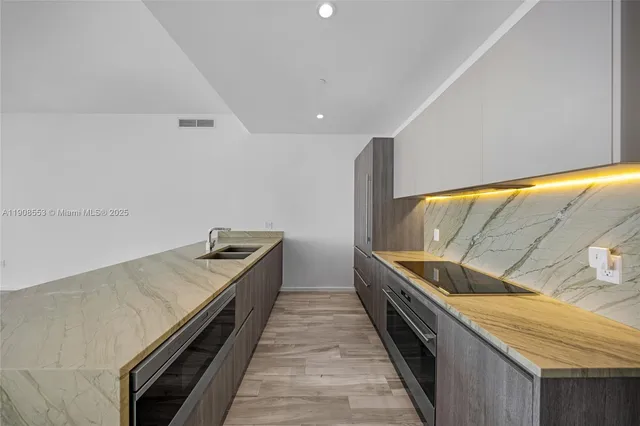 a kitchen with a stove and a sink