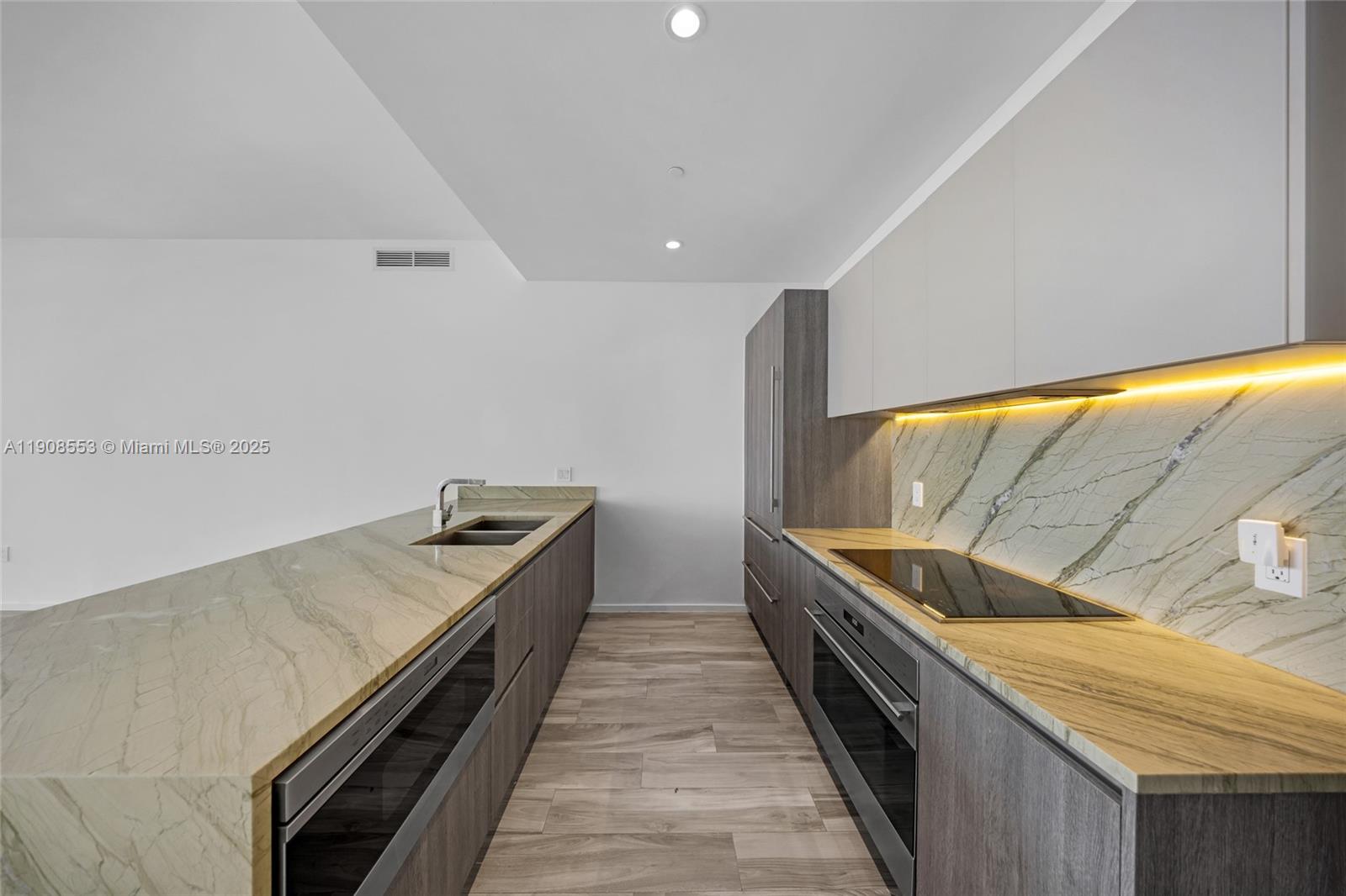 801 South Miami Avenue, Unit 5204 Miami, FL 33131 - Photo 2 of 31 a kitchen with a stove and a sink