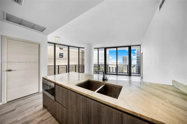 a kitchen with a sink and large window