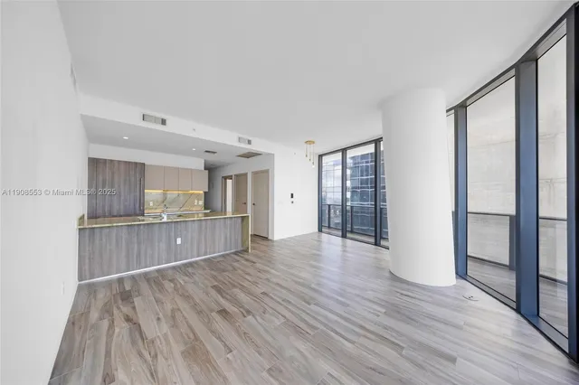 a view of a room with wooden floor and window