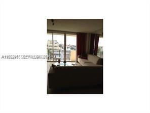 9195 Collins Avenue, Unit 614 Surfside, FL 33154 - Photo 6 of 12 a living room with a large window