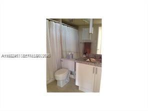 9195 Collins Avenue, Unit 614 Surfside, FL 33154 - Photo 9 of 12 a bathroom with a sink a toilet and shower