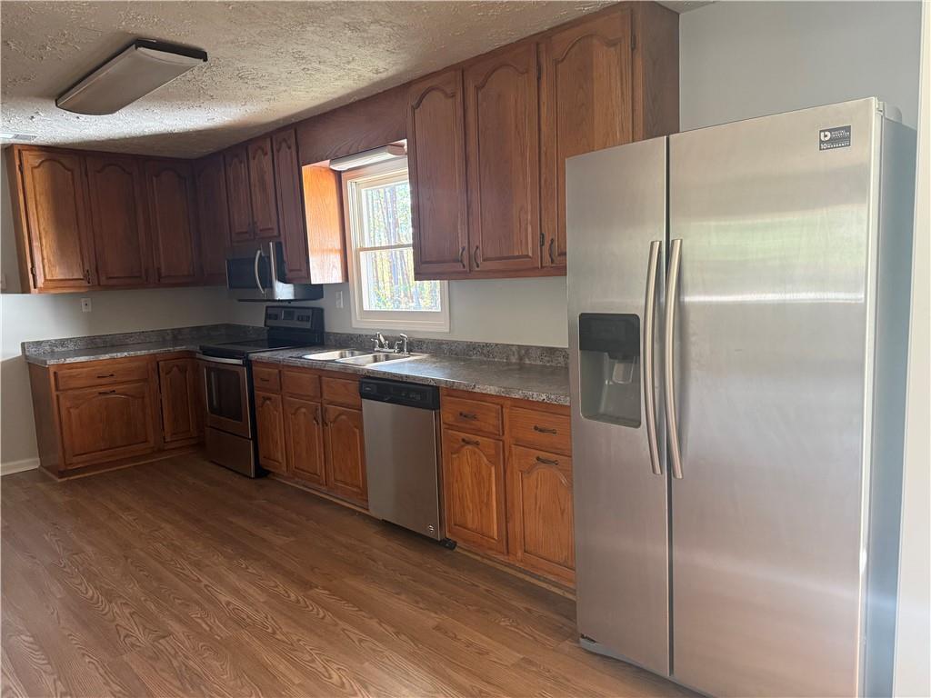 774 Mill Road McDonough, GA 30253 - Photo 11 of 37 a kitchen with stainless steel appliances granite countertop a refrigerator sink and cabinets