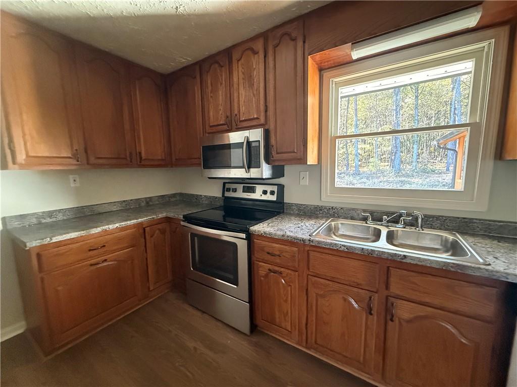 774 Mill Road McDonough, GA 30253 - Photo 12 of 37 a kitchen with a sink stove and microwave