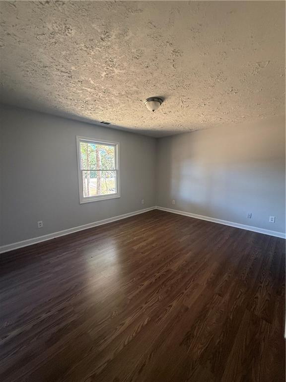 774 Mill Road McDonough, GA 30253 - Photo 13 of 37 an empty room with wooden floor and windows
