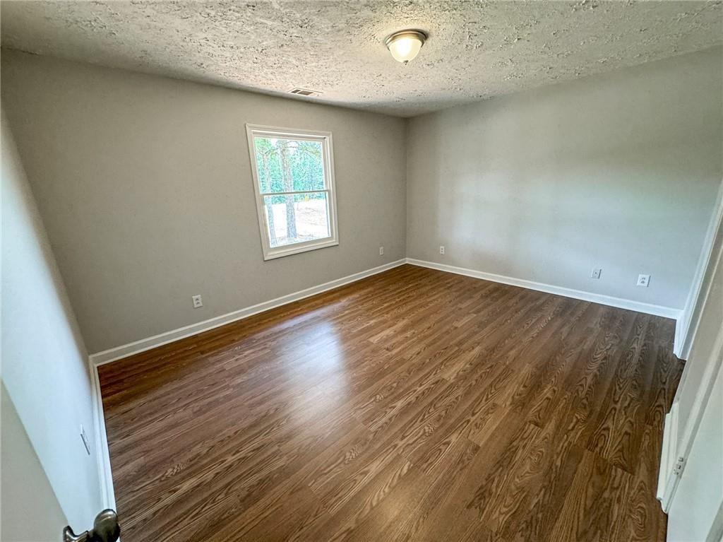 774 Mill Road McDonough, GA 30253 - Photo 14 of 37 an empty room with wooden floor and windows