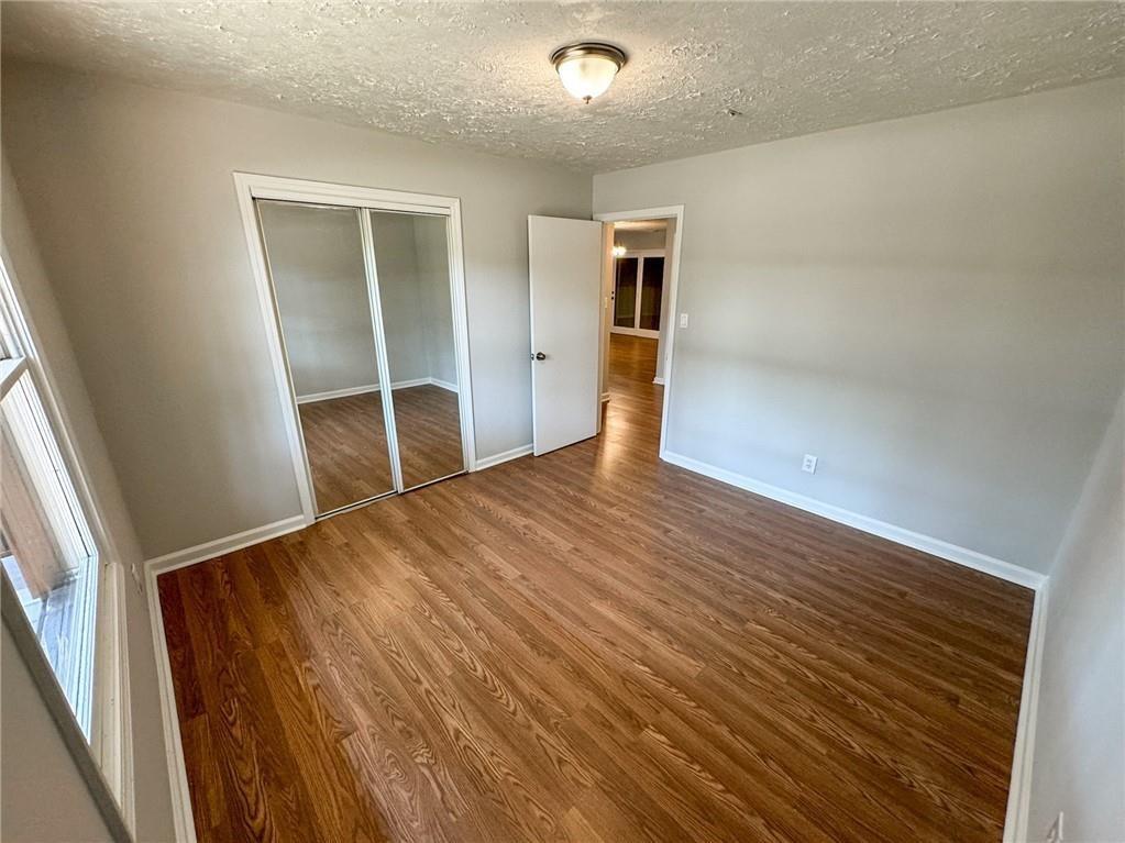 774 Mill Road McDonough, GA 30253 - Photo 16 of 37 a view of an empty room with wooden floor and a window