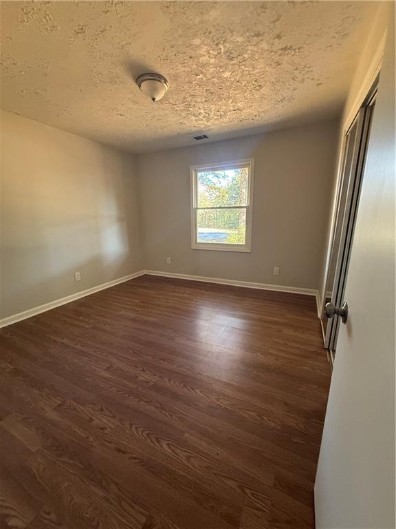 774 Mill Road McDonough, GA 30253 - Photo 17 of 37 an empty room with wooden floor and windows